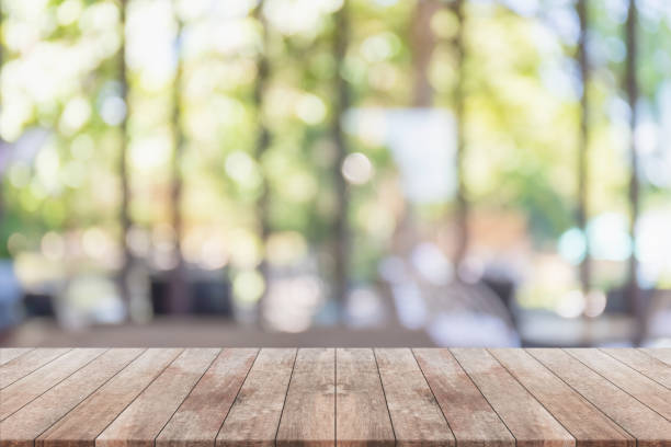 istock Empty wood table top and blurred coffee shop, cafe and restaurant interior background - can used for display or montage your products. 1335162766