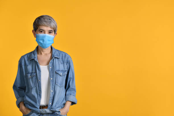 istock Asian woman wearing surgical mask 1335164911