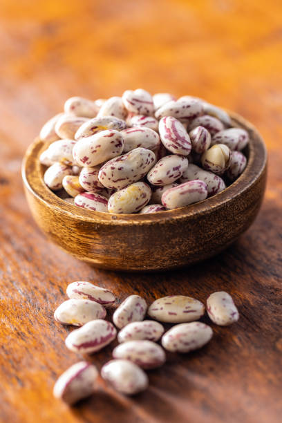 Cranberry beans. Borlotti beans in bowl on wooden table.