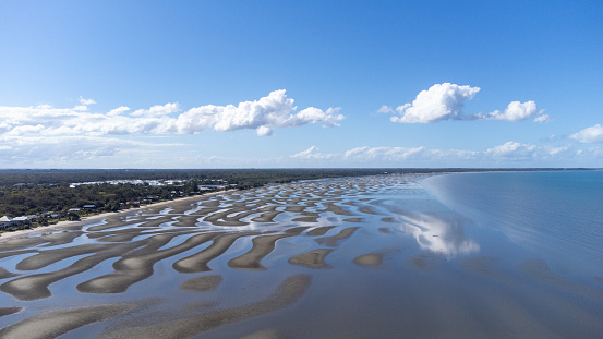 Low tide reveals abstract sand patterns at the village of Beachmere on the edge of Moreton Bay in Queensland Australia