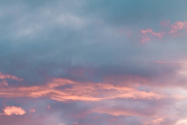 istock Sunset in Russia in spring. Beautiful light pink clouds on a blue sky. Background. Copy space 1335166907