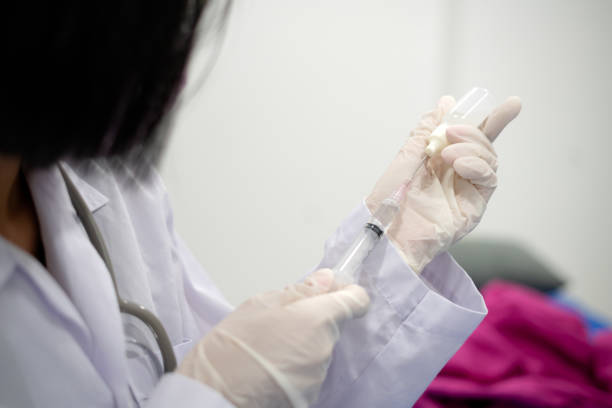 istock docter use syringe and bottle of drug 1335167073