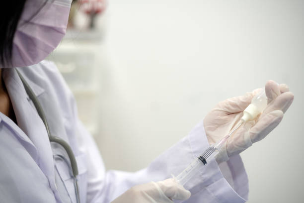 istock docter use syringe and bottle of drug 1335167113