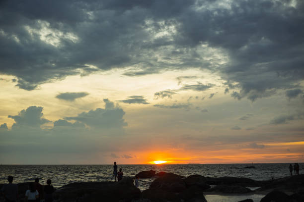 istock silhouete of rock at beach when sunset on cloudy sky 1335168010