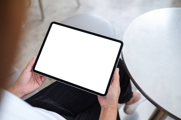 istock mockup image of a woman holding digital tablet with blank white desktop screen 1335168036