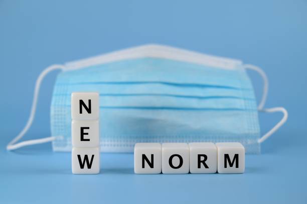istock NEW NORM wording with protective facemask on the background 1335168247