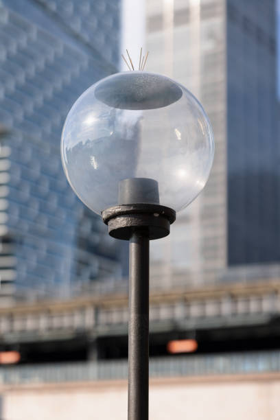 istock Electric streetlight with an office building background 1335168962