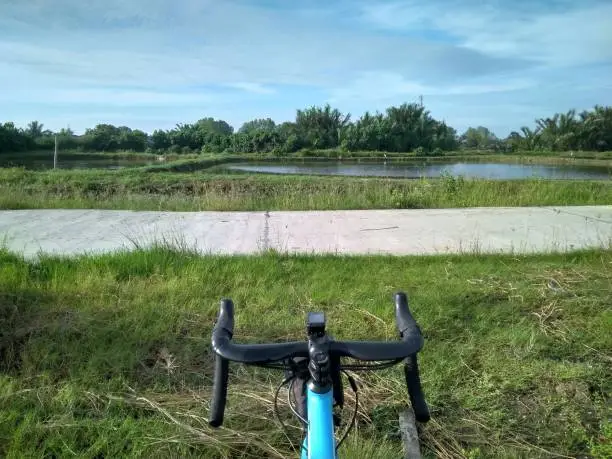 Cycling in a fishing village with lots of fish ponds