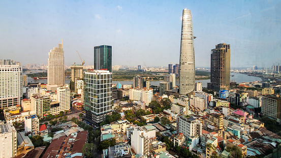 Aerial panoramic cityscape view of Ho Chi Minh city and Saigon river, Vietnam. Center of heart business at downtown with buildings and towers. Travel and business concept.
