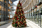 Christmas Tree With Red And Gold Colored Ornaments In Shopping Mall