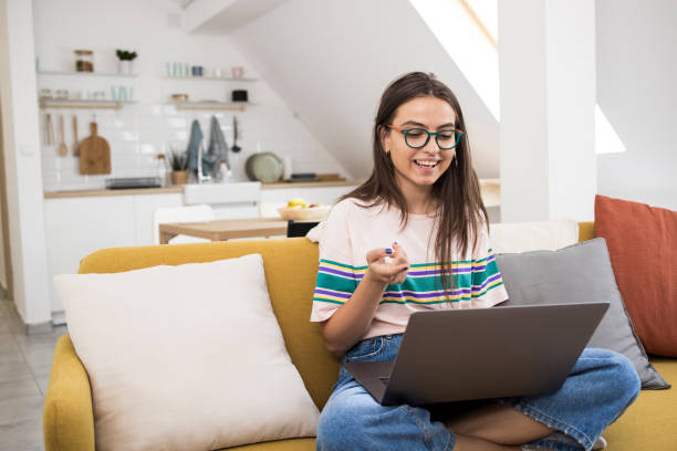 istock Girl making a video call on her laptop 1335173998
