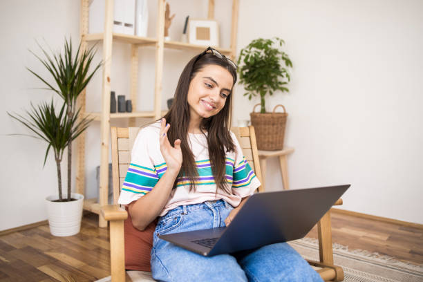 istock Happy girl having a video call on her laptop 1335174010