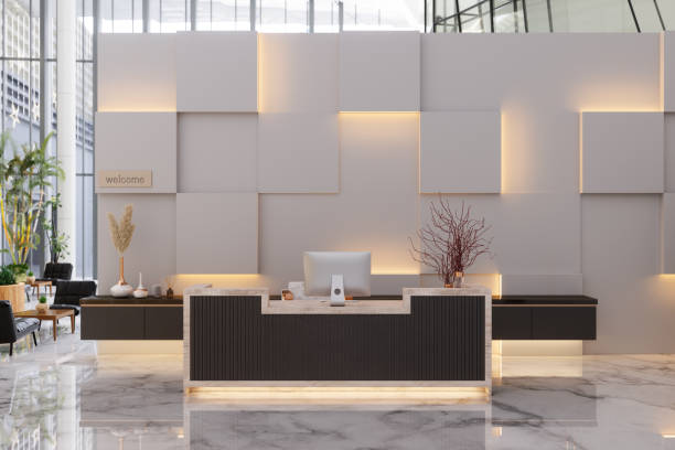 front view of reception desk in luxury hotel or company lobby entrance. lounge area with black colored leather armchairs background. - hotel desk reception imagens e fotografias de stock