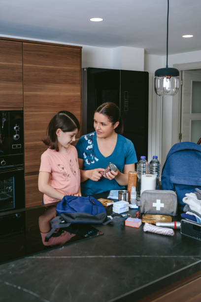 istock Mother explaining to her daughter how to prepare emergency backpack 1335180141