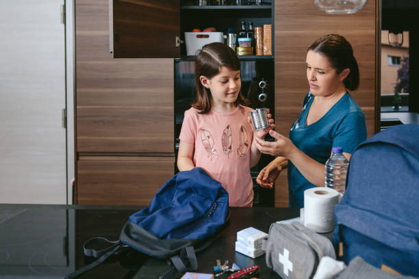 istock Mother preparing emergency backpack with her daughter 1335180144