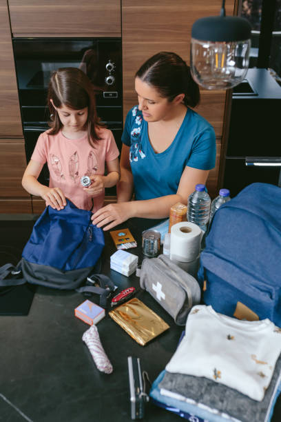 istock Mother preparing emergency backpack with her daughter 1335180147