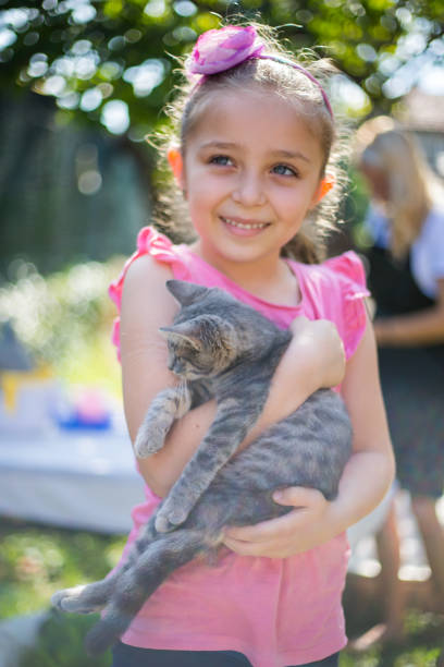 istock Cute Young Caucasian Girl Holding Kitten 1335180178