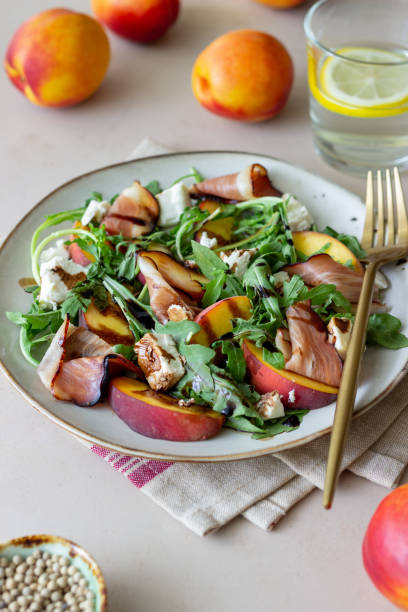istock Salad with peaches, arugula, cheese and jamon. Healthy eating. 1335183046