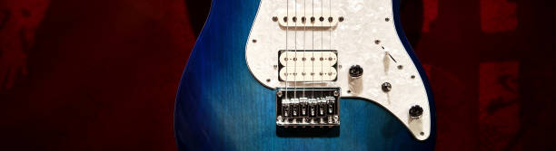 istock Blue and white electric guitar with red background 1335183868