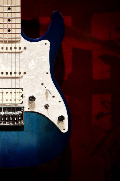 istock Blue and white electric guitar with red background 1335183895