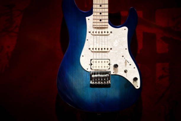 istock Blue and white electric guitar with red background 1335183927