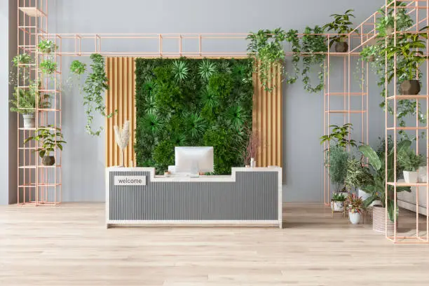 Photo of Eco-Friendly Office Or Hotel Lobby Interior With Reception Desk, Houseplants And Vertical Garden Background.