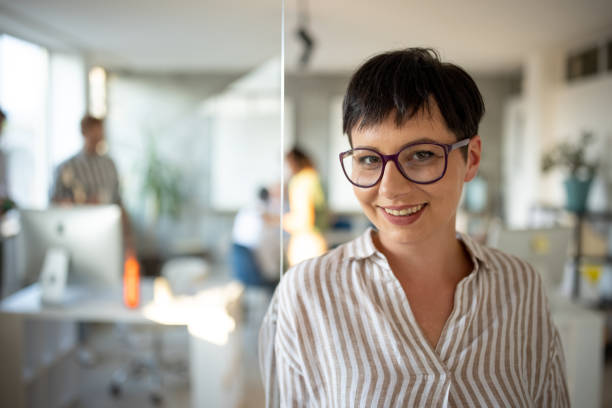istock Portrait of female manager in open space workplace 1335186734