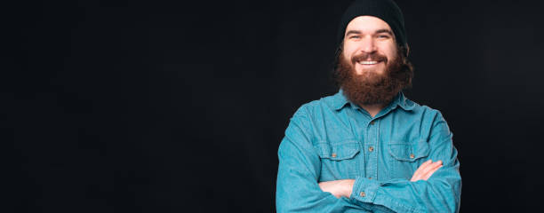 istock Handsome confident man is looking at the camera smiling with his arms crossed. 1335187853