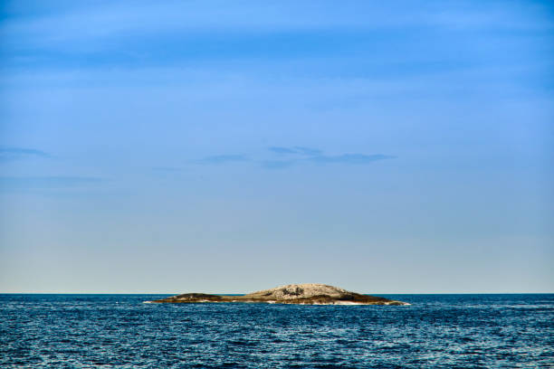 istock small rocks at the open sea in cloudy sky summer day with empty copy space 1335188074
