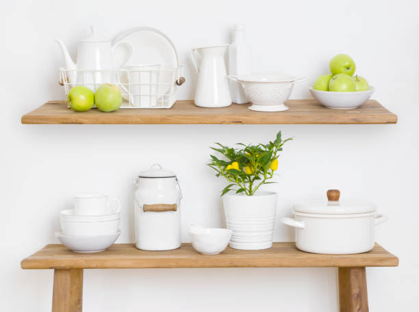 istock Kitchen shelf and table with utensils, pots and green apples 1335190472