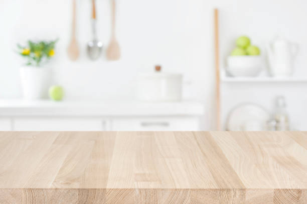 istock Wood table top on blur modern kitchen room counter background 1335191185