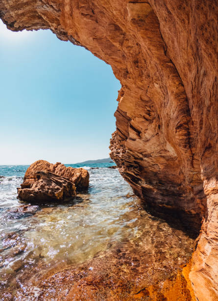 istock Cliffs on the Beach and Clear Sea 1335192035