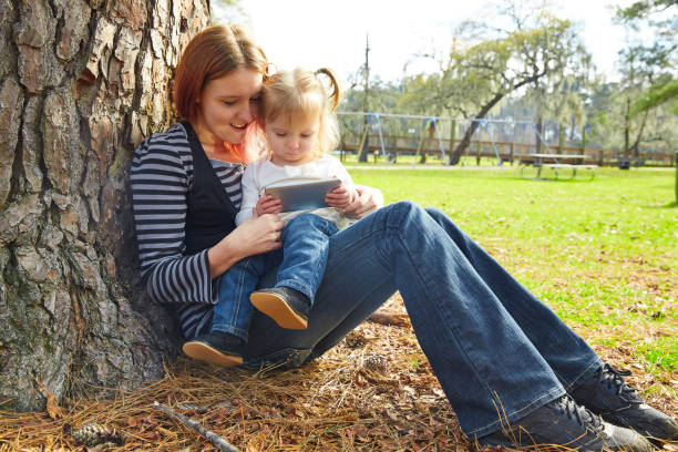 istock mother and daughter playing with smartphone 1335193397
