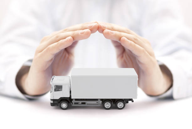 istock White cargo delivery truck protected by hands 1335193988