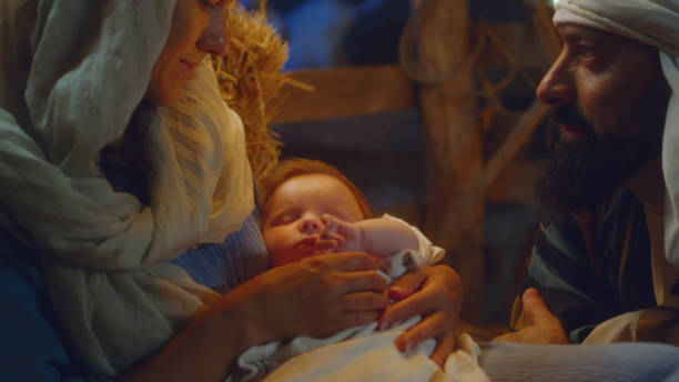 istock Mary and Joseph admiring sleeping baby Jesus 1335197421