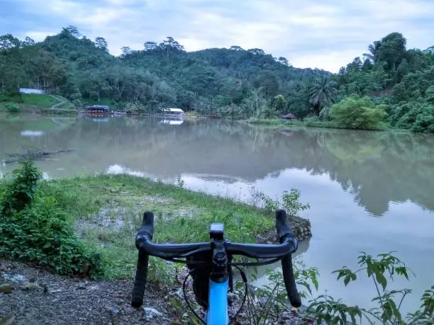 Beautiful view of lakes and hills in Indonesia from the bicycle handlebar's point of view