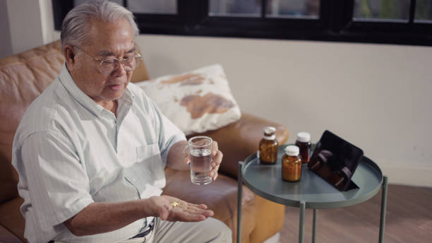 istock Senior man takes the pills after waking up from sleep 1335197780