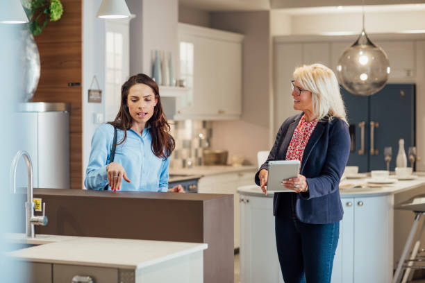 istock Saleswoman Assisting Potential Customer 1335197939