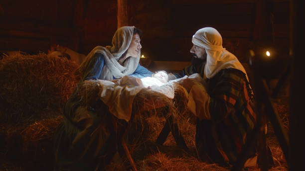 istock Mary and Joseph caressing baby Jesus in illuminated manger 1335199147