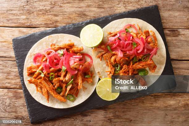 Yucatan Braised Pulled Pork Cochinita Pibil With Tortilla And Marinated Onion Closeup In The Slate Board Horizontal Top View Stock Photo - Download Image Now