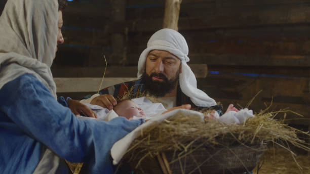istock Mary and Joseph admiring baby Jesus 1335200880