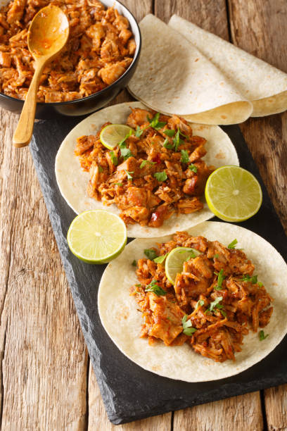 istock Chilorio is a scrumptious northern Mexican dish made with shredded pork simmered in a delicious chili sauce with spices closeup in the slate board. Vertical 1335201142