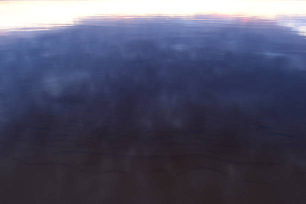 istock Lake water reflects the sky at sunset 1335201448