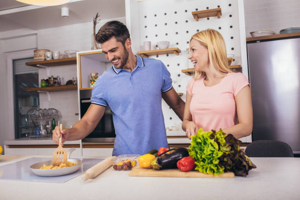 istock Romantic young couple cooking together in the kitchen,having a great time together. 1335202306