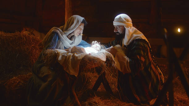 istock Mary and Joseph caressing baby Jesus in illuminated manger 1335202489