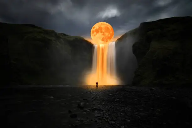 Photo of Orange moon over great waterfall