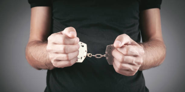 istock Caucasian male hands in handcuffs. Arrest 1335204752