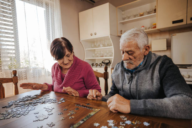 istock Senior retired couple doing jigsaw puzzle together at home 1335204783
