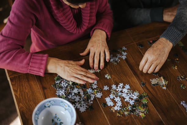 istock Concentrated senior couple doing a jigsaw puzzle at home 1335204794