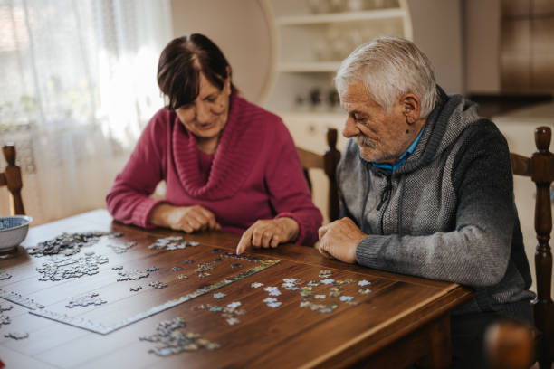 istock Concentrated senior couple doing a jigsaw puzzle at home 1335206418